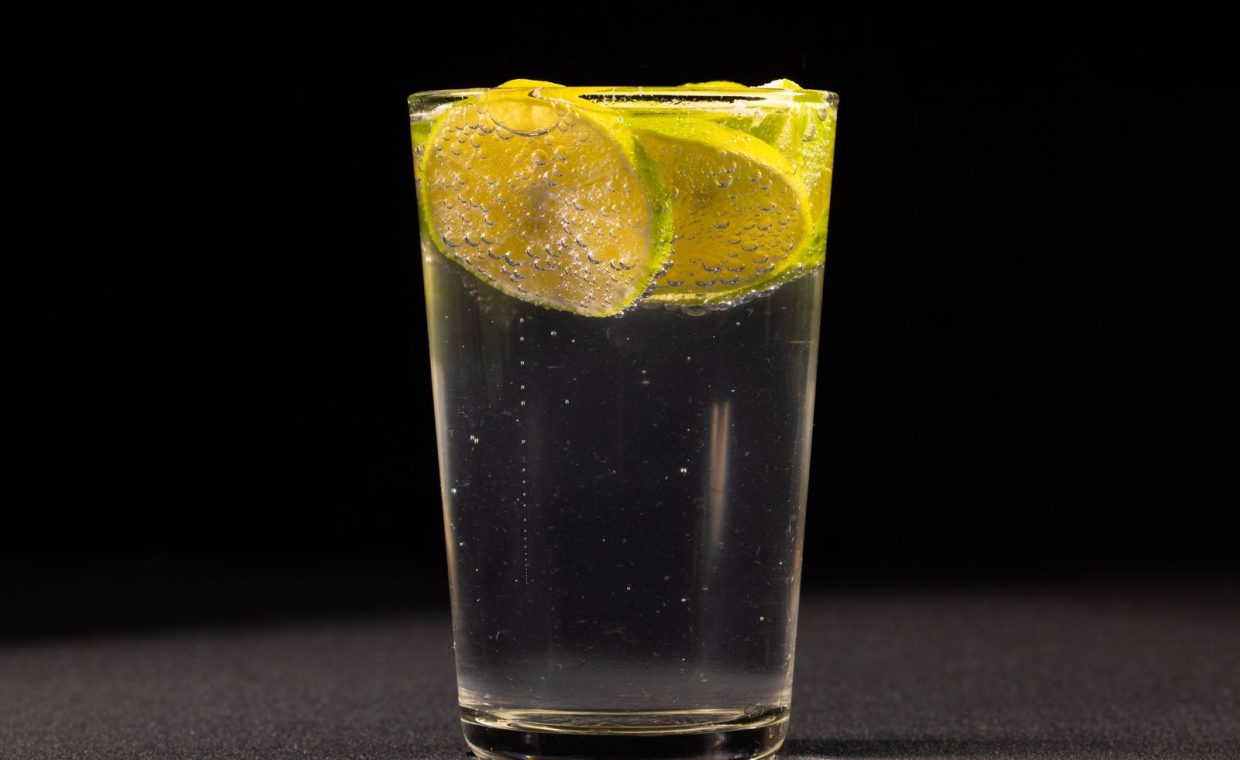 Close-up of a refreshing lemon and lime sparkling drink in a glass, perfect for a cool, invigorating experience.