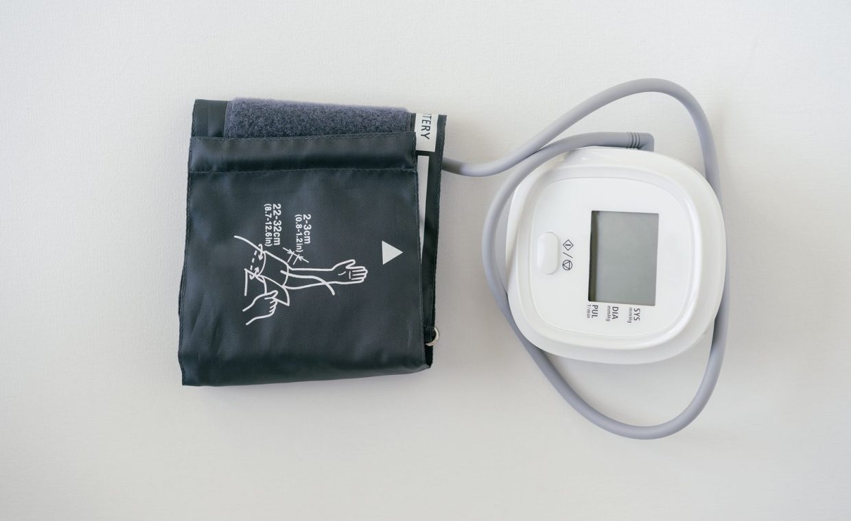 A digital sphygmomanometer on a white background, used for measuring blood pressure.