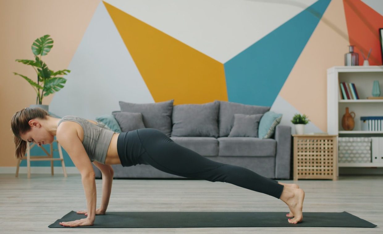 Woman doing a plank exercise on a yoga mat.