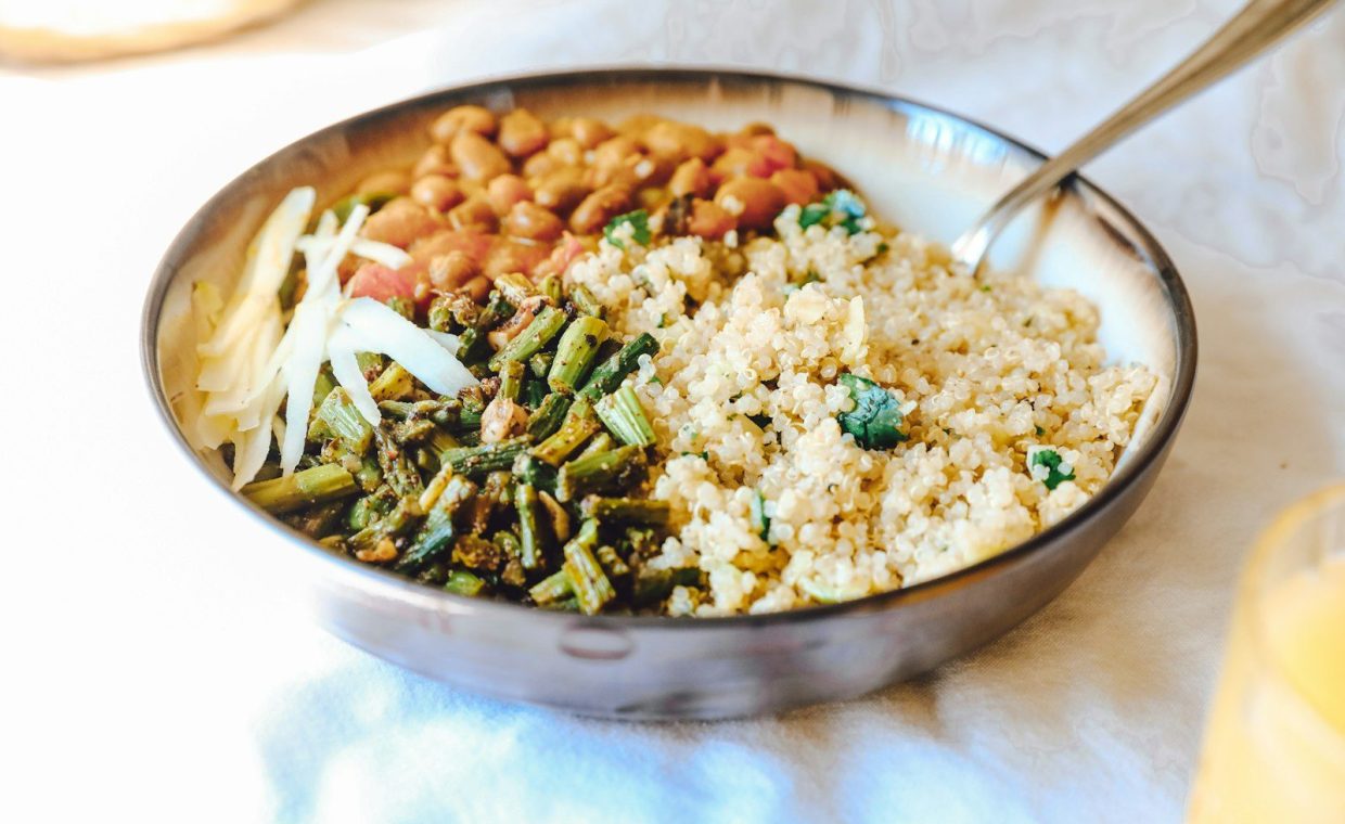 cooked rice with green peas and carrots on stainless steel bowl
