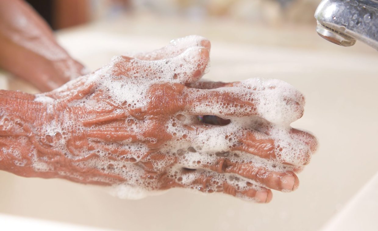 A detailed shot of hands covered in soap lather, highlighting hygiene and cleanliness.